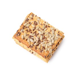 Photo of Stack of cereal crackers with flax, sunflower and sesame seeds isolated on white, top view