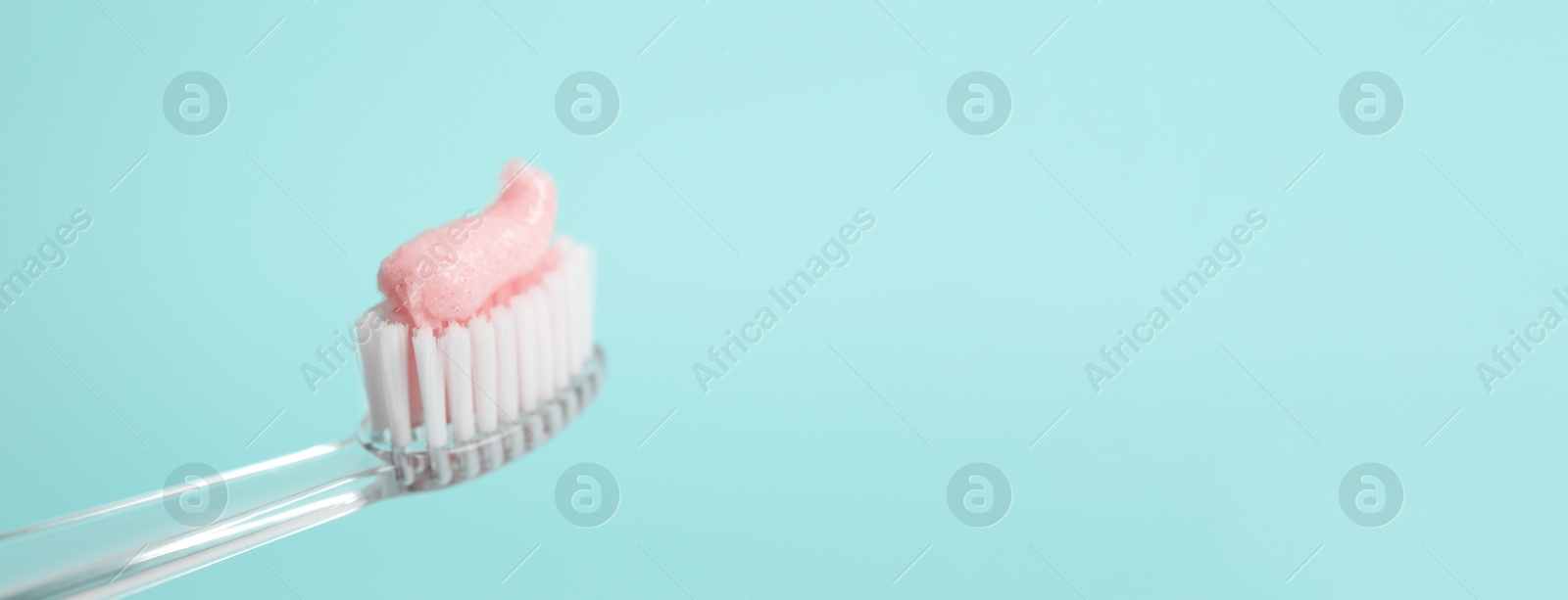 Image of Brush with toothpaste on light blue background, space for text. Banner design