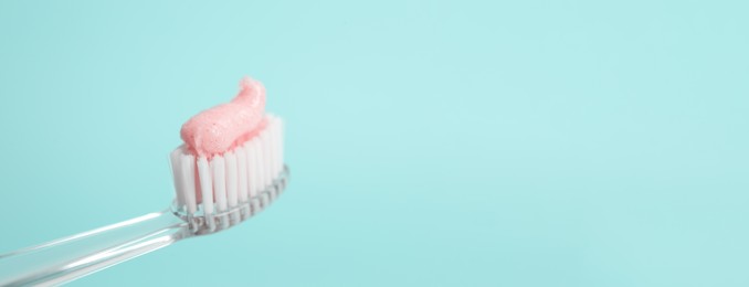 Image of Brush with toothpaste on light blue background, space for text. Banner design