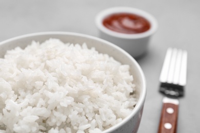 Bowl of boiled rice on table, closeup