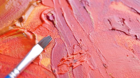 Photo of Brush on artist's palette with mixed paints, closeup. Space for text