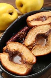 Photo of Tasty baked quinces with spices and honey in dish on table, closeup