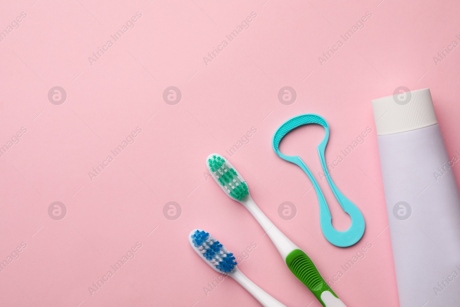 Photo of Flat lay composition with tongue cleaner on color background, space for text