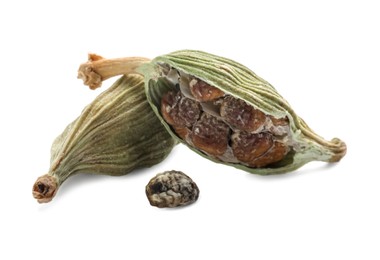 Photo of Dry green cardamom pods on white background, closeup