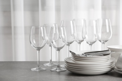 Set of clean dishes on the table against blurred background