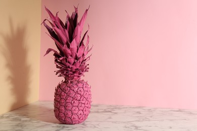Photo of Pink pineapple on color background, space for text. Creative concept