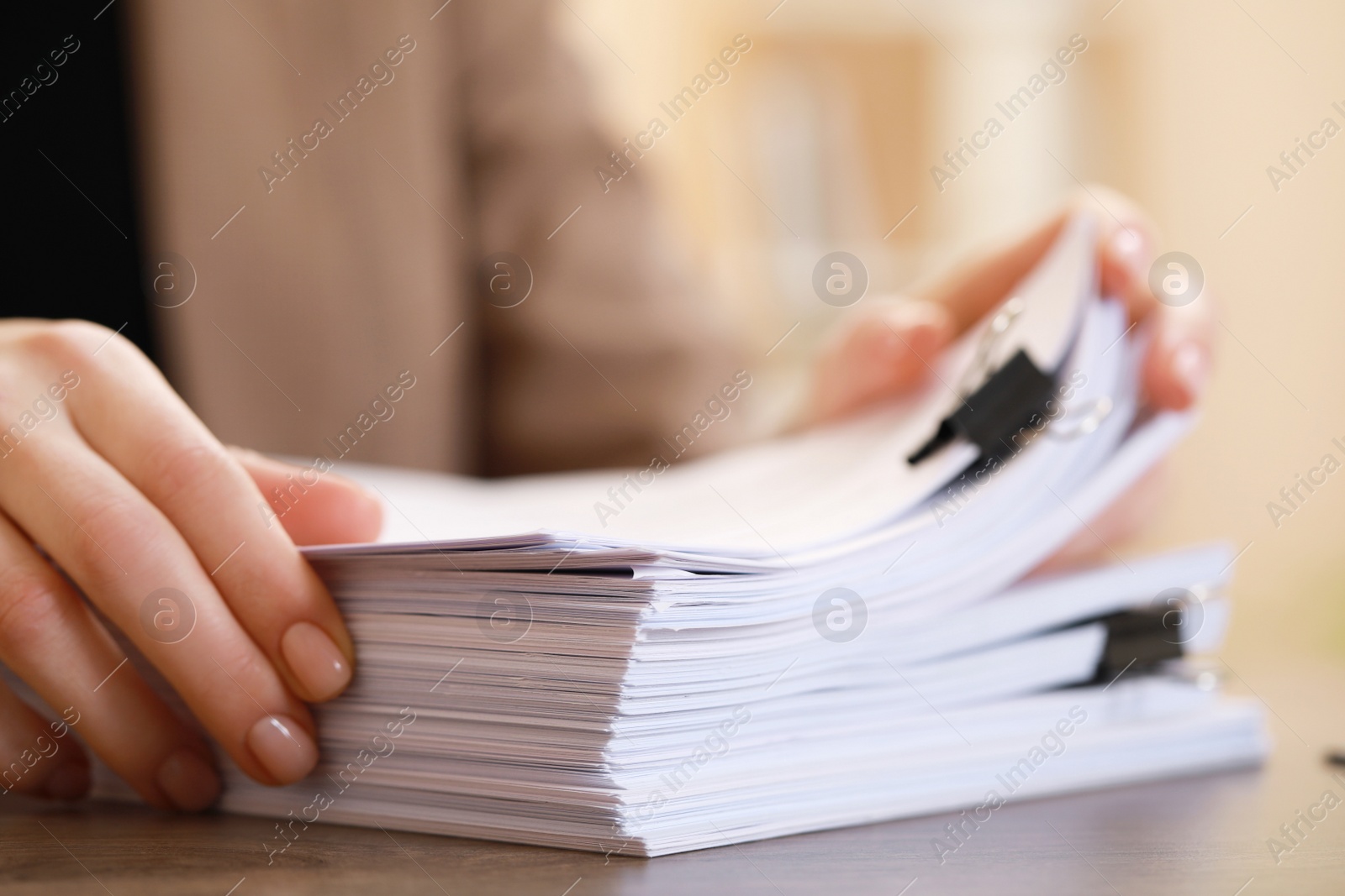 Photo of Woman working with documents at table in office, closeup