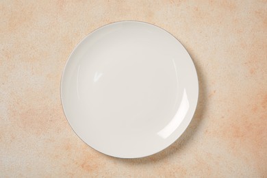 One ceramic plate on beige table, top view