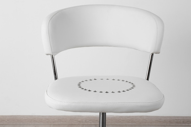 Chair with pins near white wall. Hemorrhoids concept