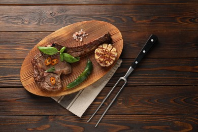 Delicious fried beef meat served on wooden table, flat lay. Space for text