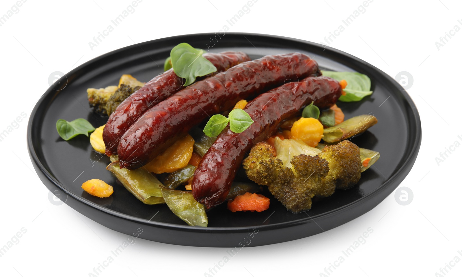 Photo of Delicious smoked sausages and baked vegetables isolated on white