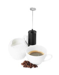 Photo of Mini mixer (milk frother), cup, coffee beans and pitcher isolated on white