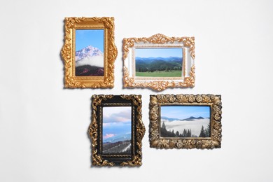 Vintage frames with photos of beautiful landscapes hanging on white wall