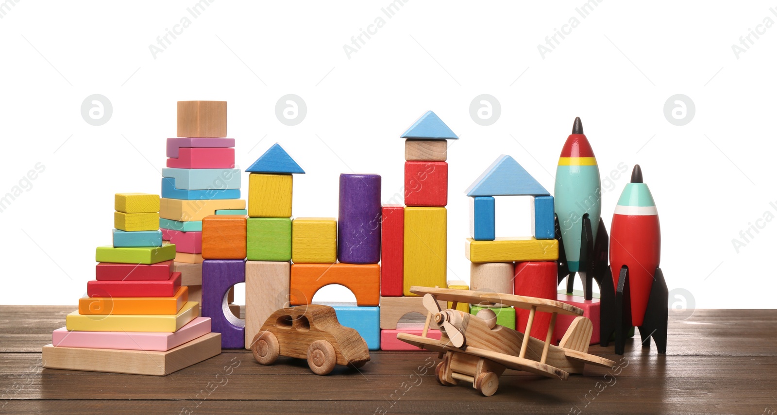 Photo of Set of different toys on wooden table against white background