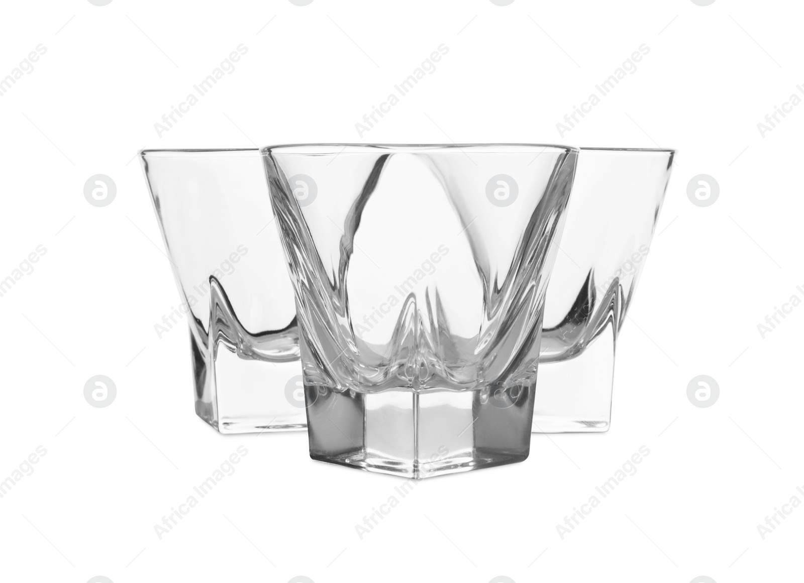 Photo of Elegant clean empty shot glasses isolated on white