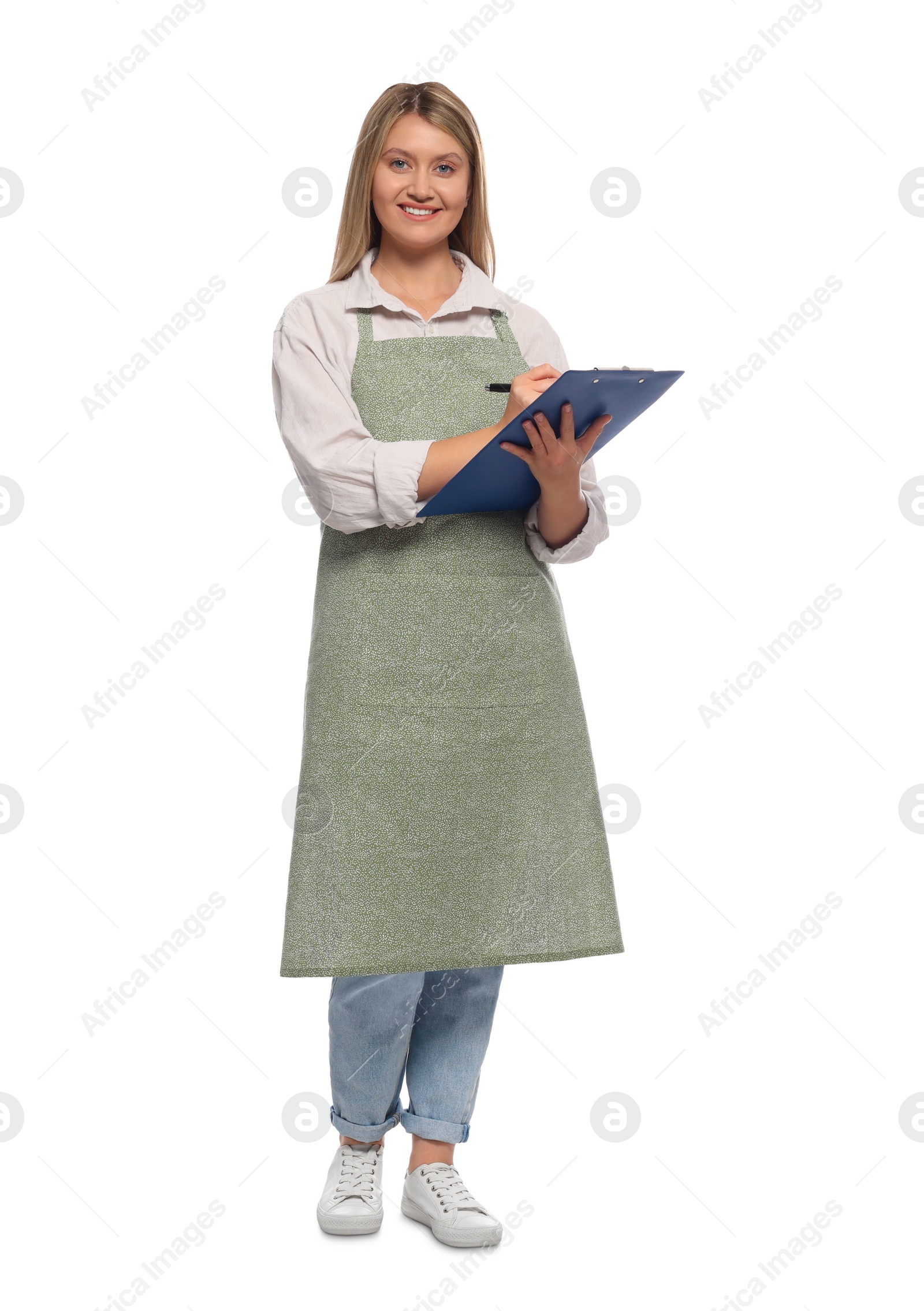 Photo of Beautiful young woman in clean apron with clipboard on white background