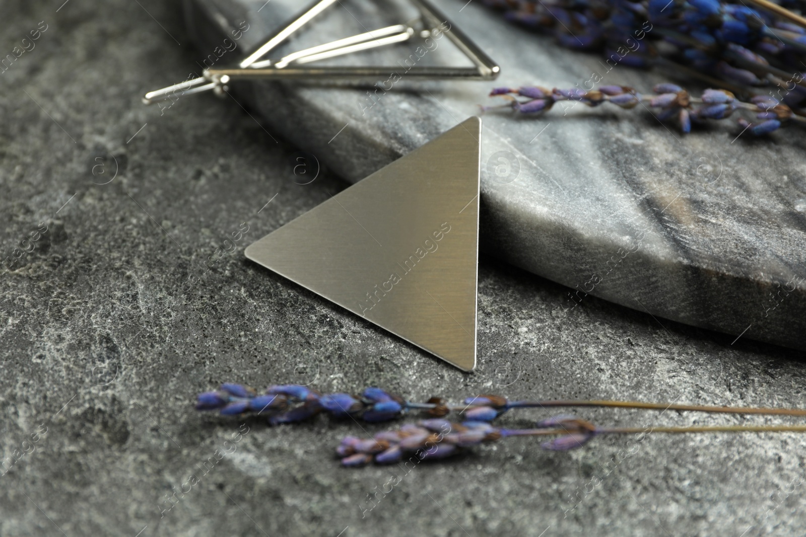 Photo of Beautiful silver hair clips and flowers on grey table