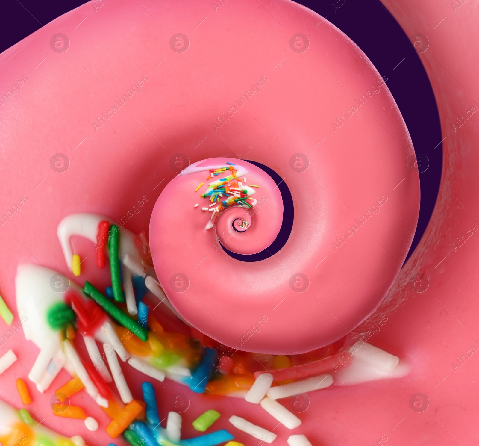 Image of Twisted donut with strawberry icing and sprinkles on purple background, spiral effect