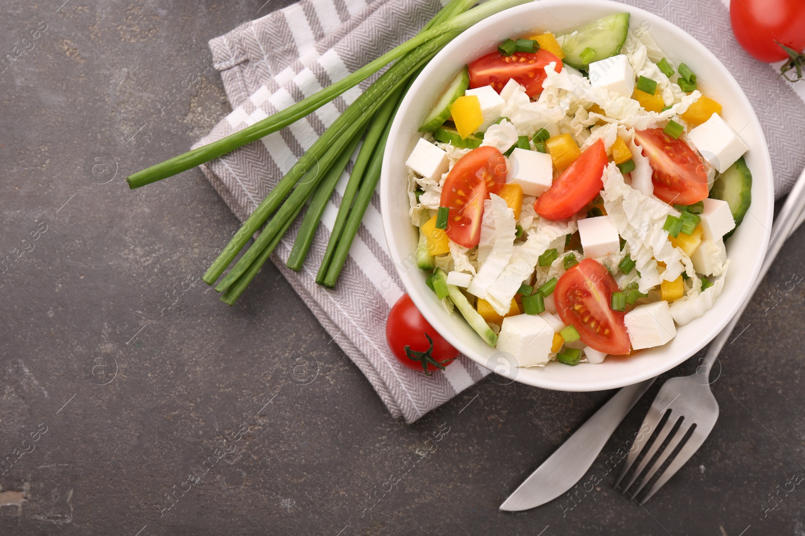 Photo of Tasty salad with Chinese cabbage served on grey table, top view. Space for text