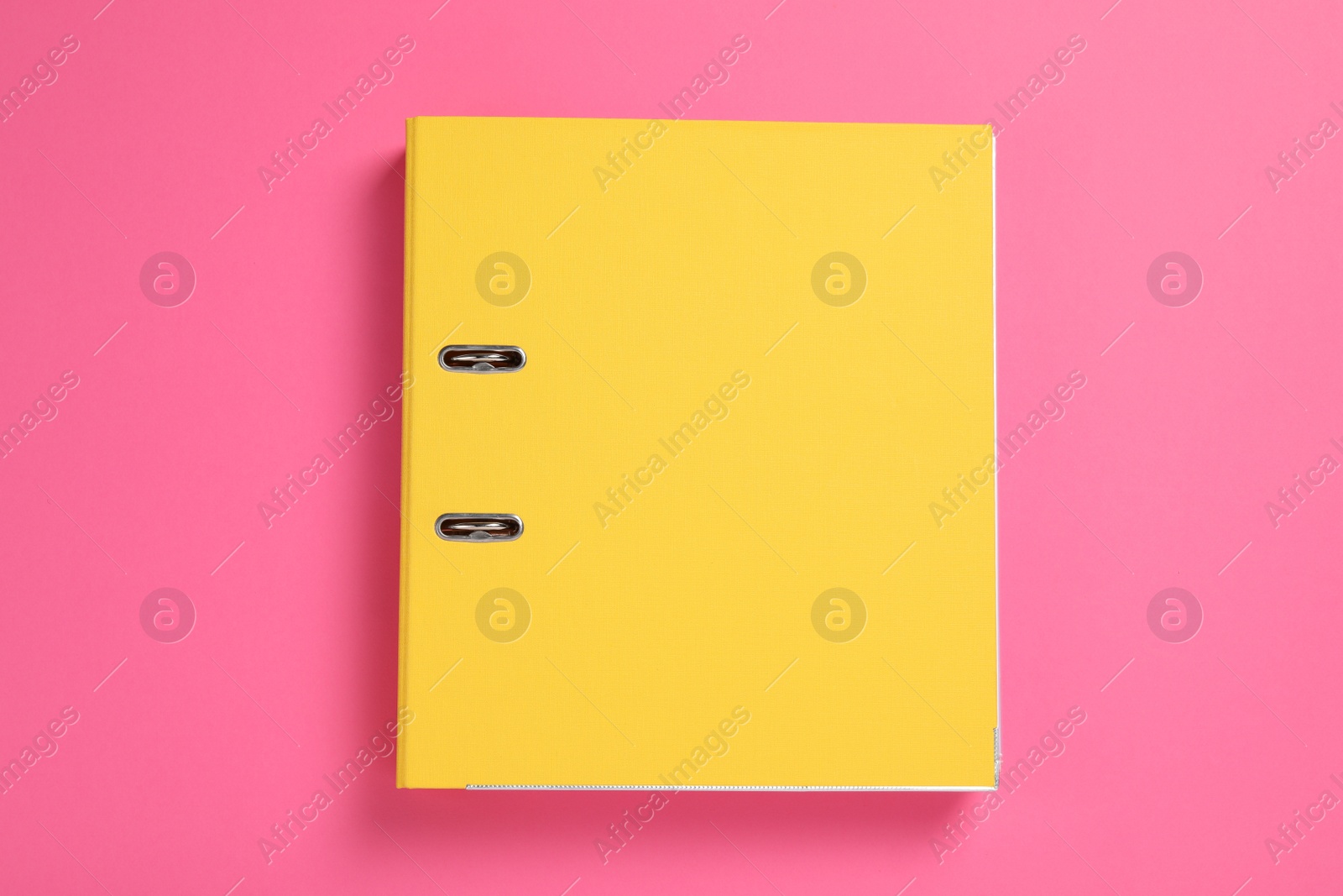 Photo of Yellow office folder on pink background, top view