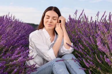 Photo of Portrait of beautiful young woman in lavender field