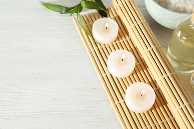 Photo of Spa composition with burning candles on table, space for text