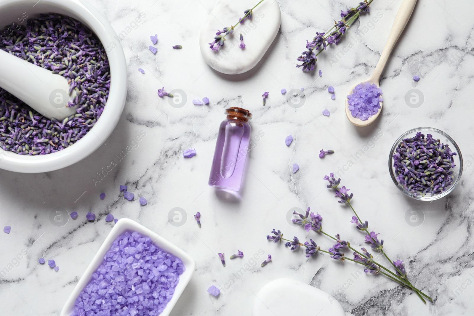 Photo of Flat lay composition with lavender flowers and natural cosmetic products on marble background