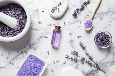 Photo of Flat lay composition with lavender flowers and natural cosmetic products on marble background