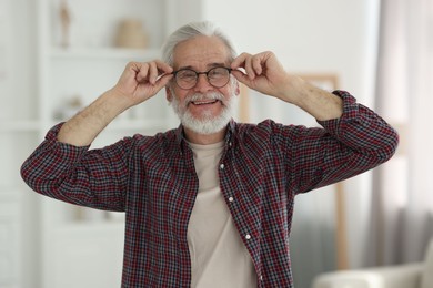 Portrait of happy grandpa with glasses indoors