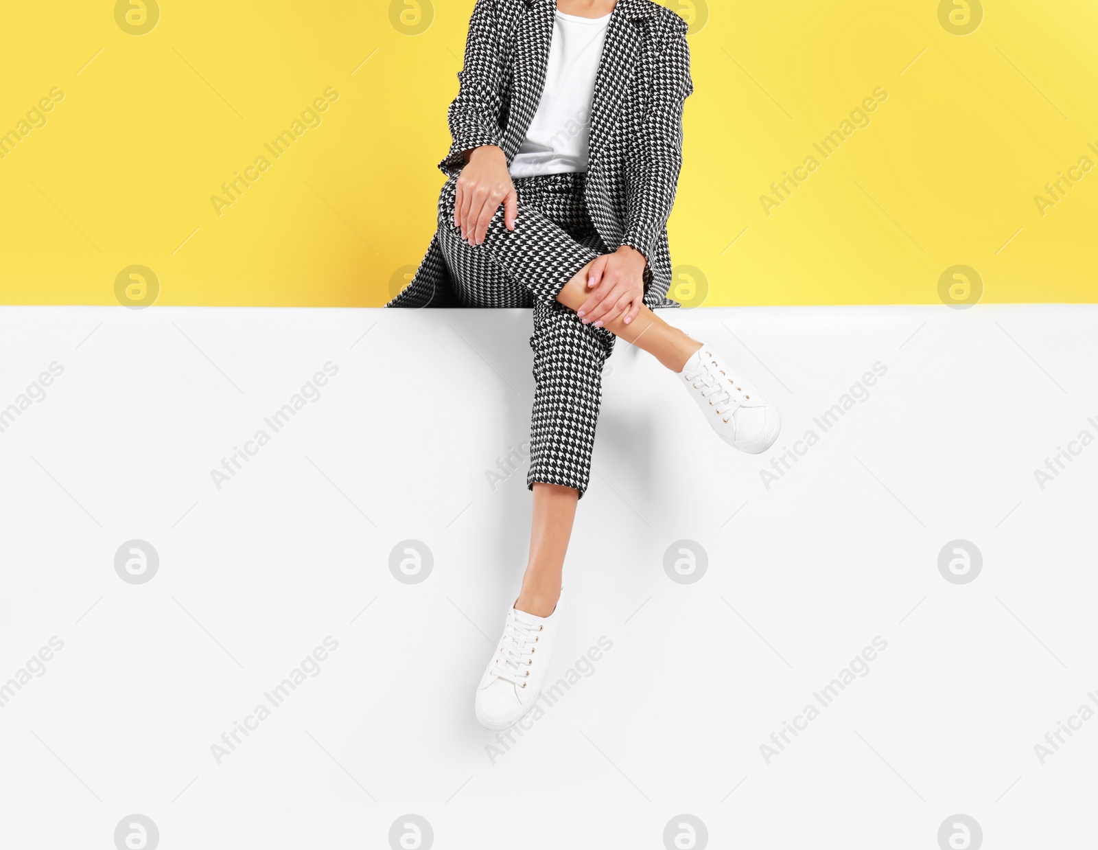 Photo of Woman wearing stylish shoes on color background, closeup