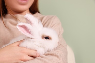 Woman with fluffy white rabbit, closeup and space for text. Cute pet