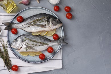 Flat lay composition with raw dorado fish on grey table. Space for text