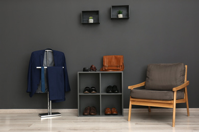 Photo of Hallway interior with stylish furniture, clothes and accessories