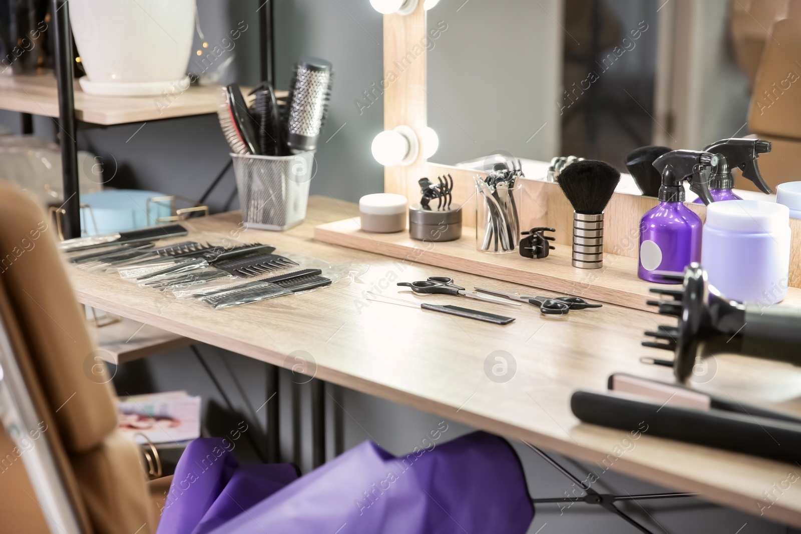 Photo of Hairdresser tools on table in salon