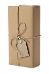 Photo of Parcel wrapped with kraft paper, twine and tag isolated on white