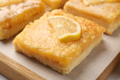 Photo of Tasty lemon bars on board, closeup view