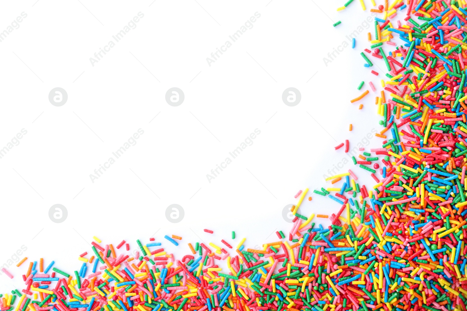 Photo of Colorful sprinkles on white background, top view. Confectionery decor