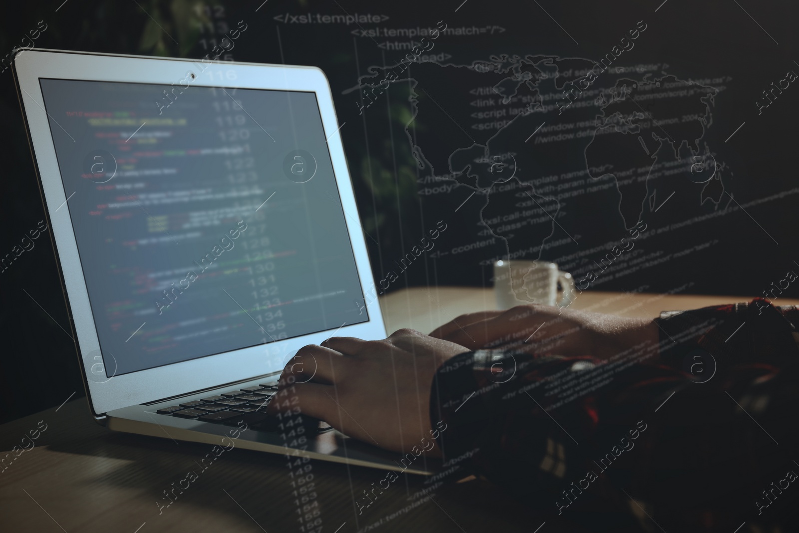 Image of Hacker working with laptop at table, closeup. Cyber attack