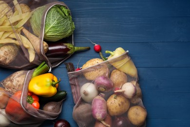 Photo of Different fresh ripe vegetables on blue wooden table, flat lay. Space for text