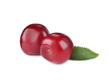 Photo of Tasty ripe red cherries with green leaf isolated on white