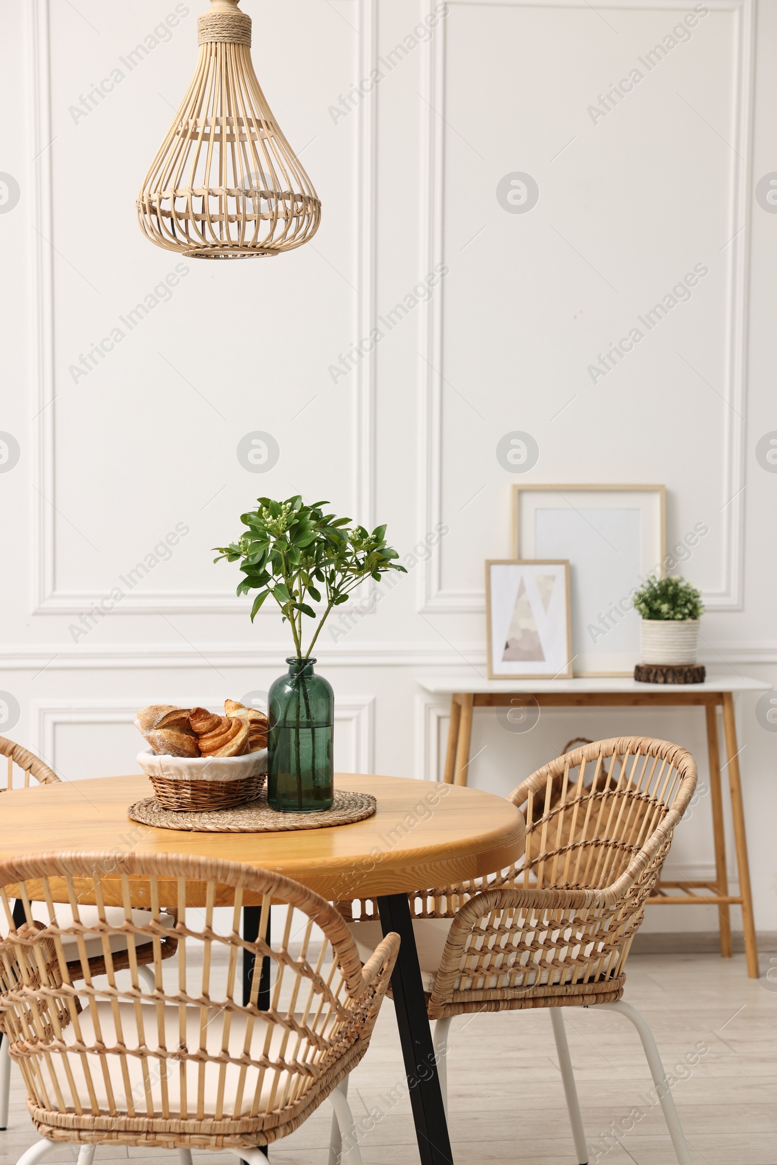 Photo of Dining room interior with comfortable furniture and plants