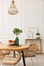 Dining room interior with comfortable furniture and plants