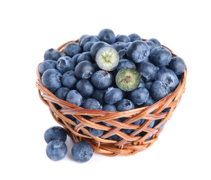 Photo of Fresh tasty blueberries in wicker basket isolated on white