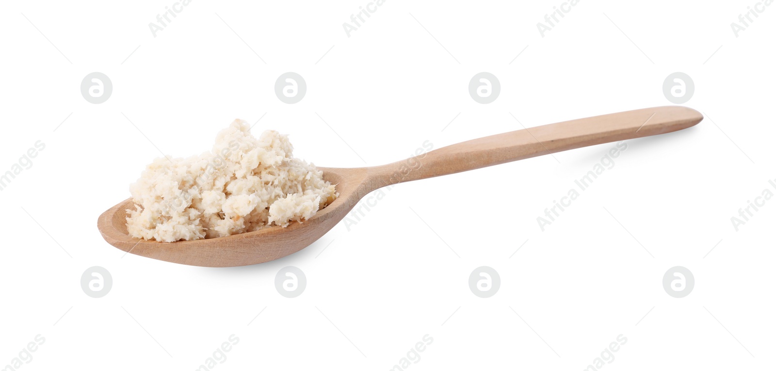 Photo of Wooden spoon with tasty prepared horseradish isolated on white