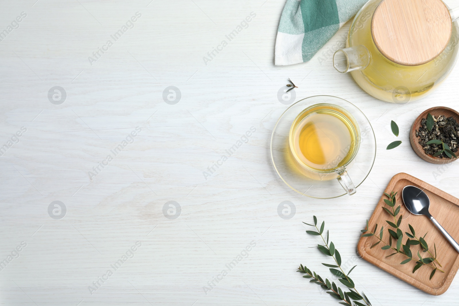 Photo of Aromatic eucalyptus tea on white wooden table, flat lay. Space for text