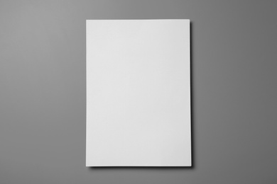 Photo of Blank paper sheets for brochure on grey background, top view. Mock up