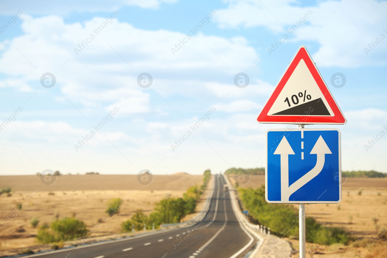 Photo of Traffic signs near empty asphalt highway. Road trip