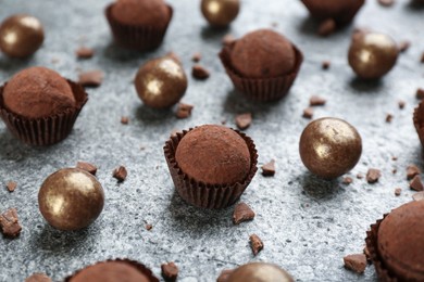 Different delicious chocolate candies on grey table, closeup