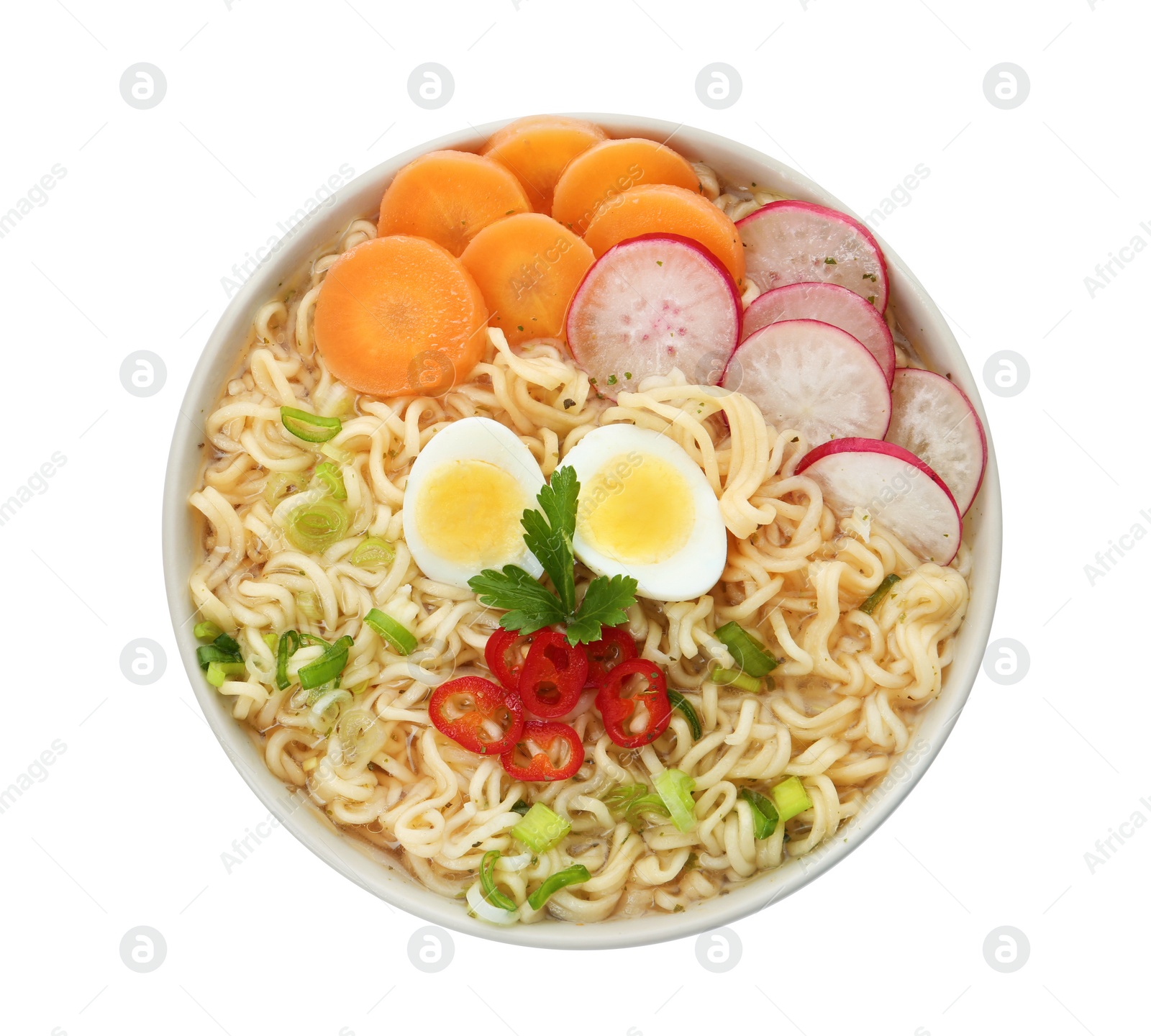 Photo of Tasty soup with instant noodles, egg and vegetables in bowl isolated on white, top view