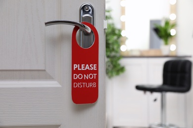 Photo of Open door with sign PLEASE DO NOT DISTURB on handle at hotel, space for text